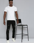 JET BLACK SKINNY JEAN WITH STUDDED BACKED RIPS