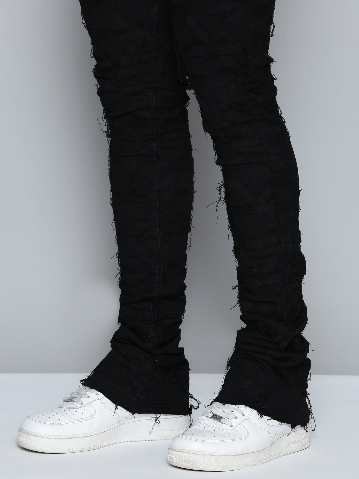 JET BLACK STACKED JEAN WITH FRINGE CUT AND SEW FROM TOP TO BOTTOM