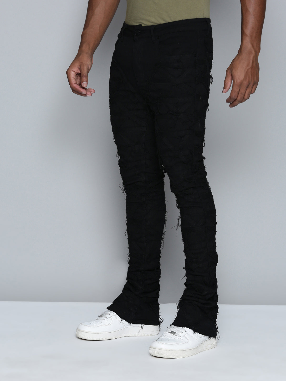 JET BLACK STACKED JEAN WITH FRINGE CUT AND SEW FROM TOP TO BOTTOM