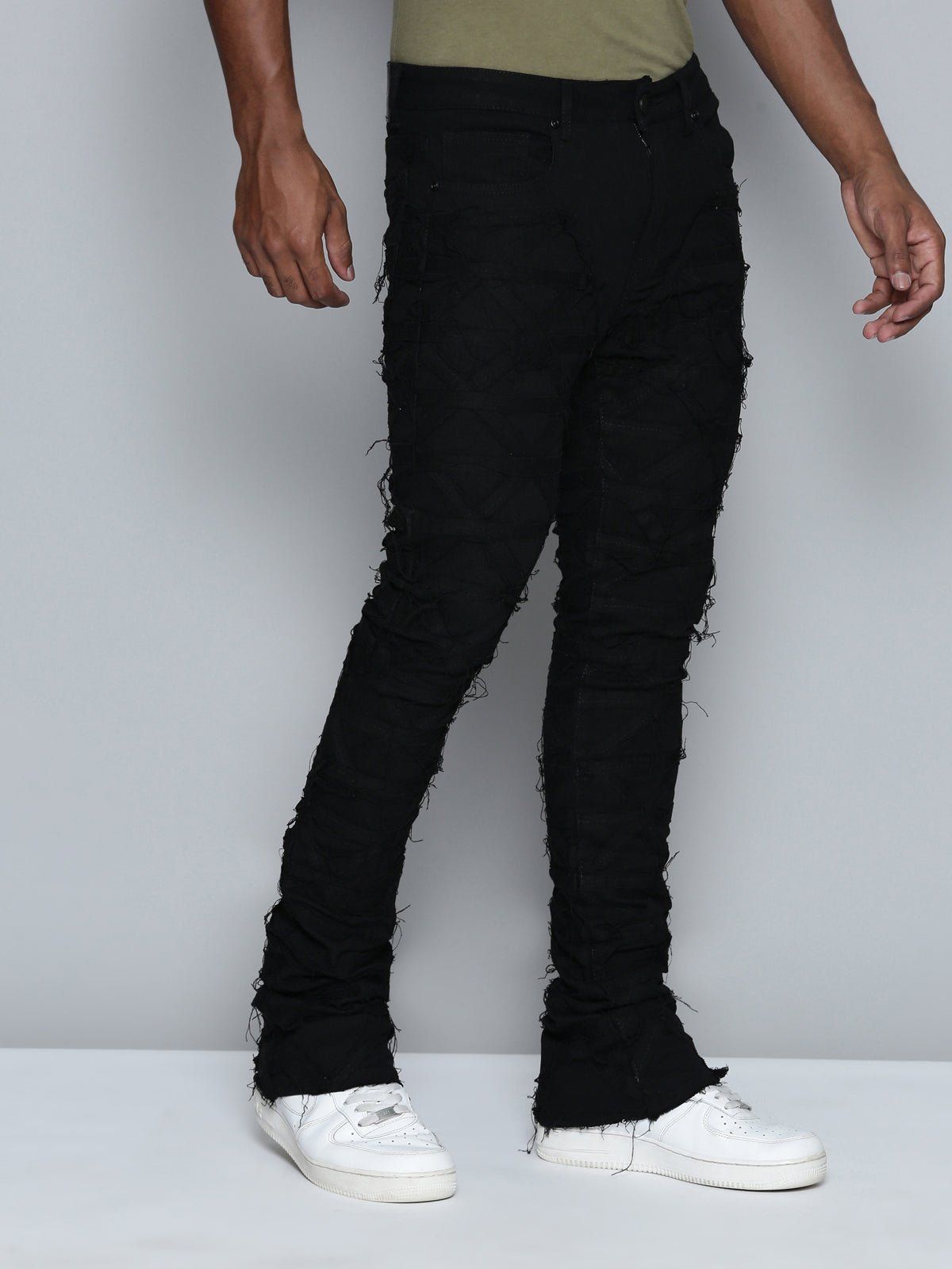 JET BLACK STACKED JEAN WITH FRINGE CUT AND SEW FROM TOP TO BOTTOM