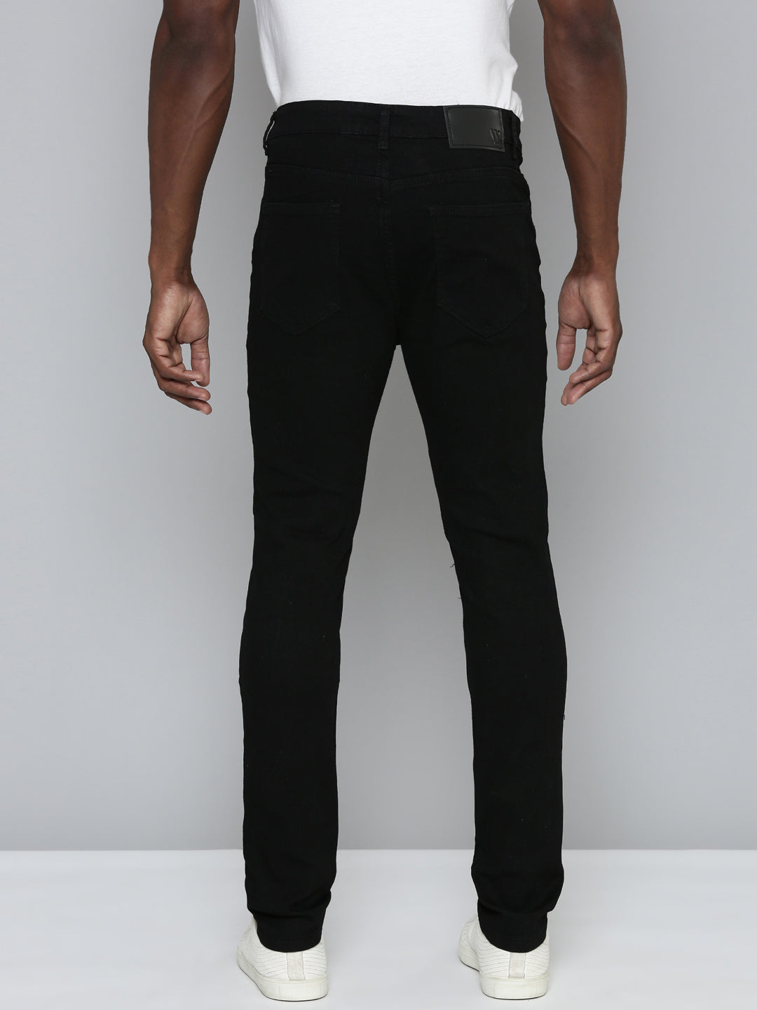 JET BLACK SKINNY JEAN WITH STUDDED BACKED RIPS