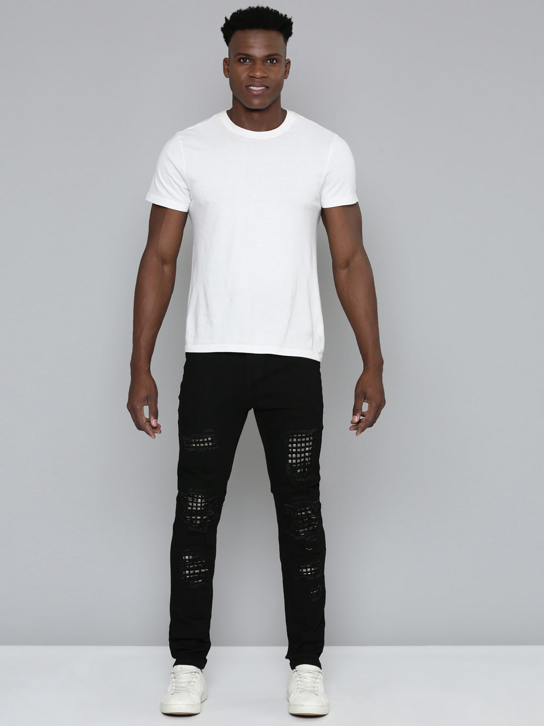 JET BLACK SKINNY JEAN WITH STUDDED BACKED RIPS
