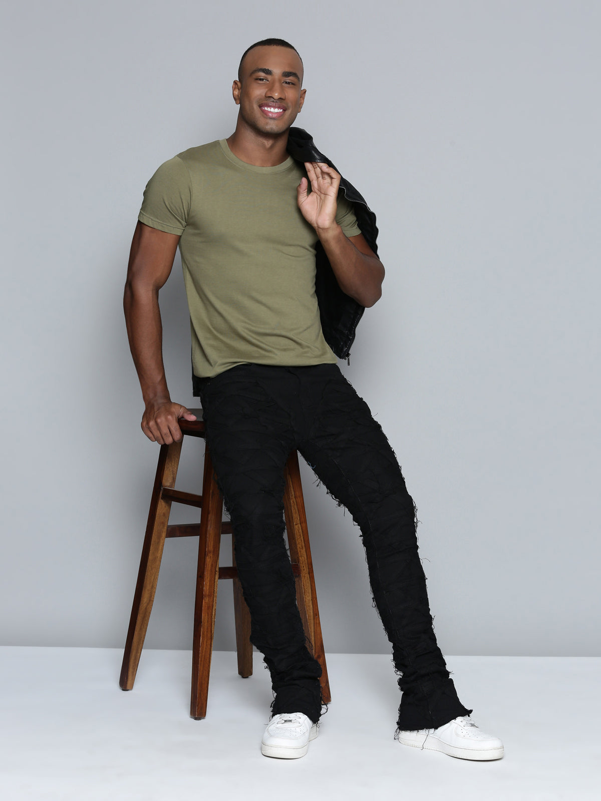 JET BLACK STACKED JEAN WITH FRINGE CUT AND SEW FROM TOP TO BOTTOM