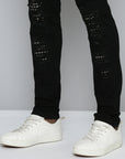 JET BLACK SKINNY JEAN WITH STUDDED BACKED RIPS