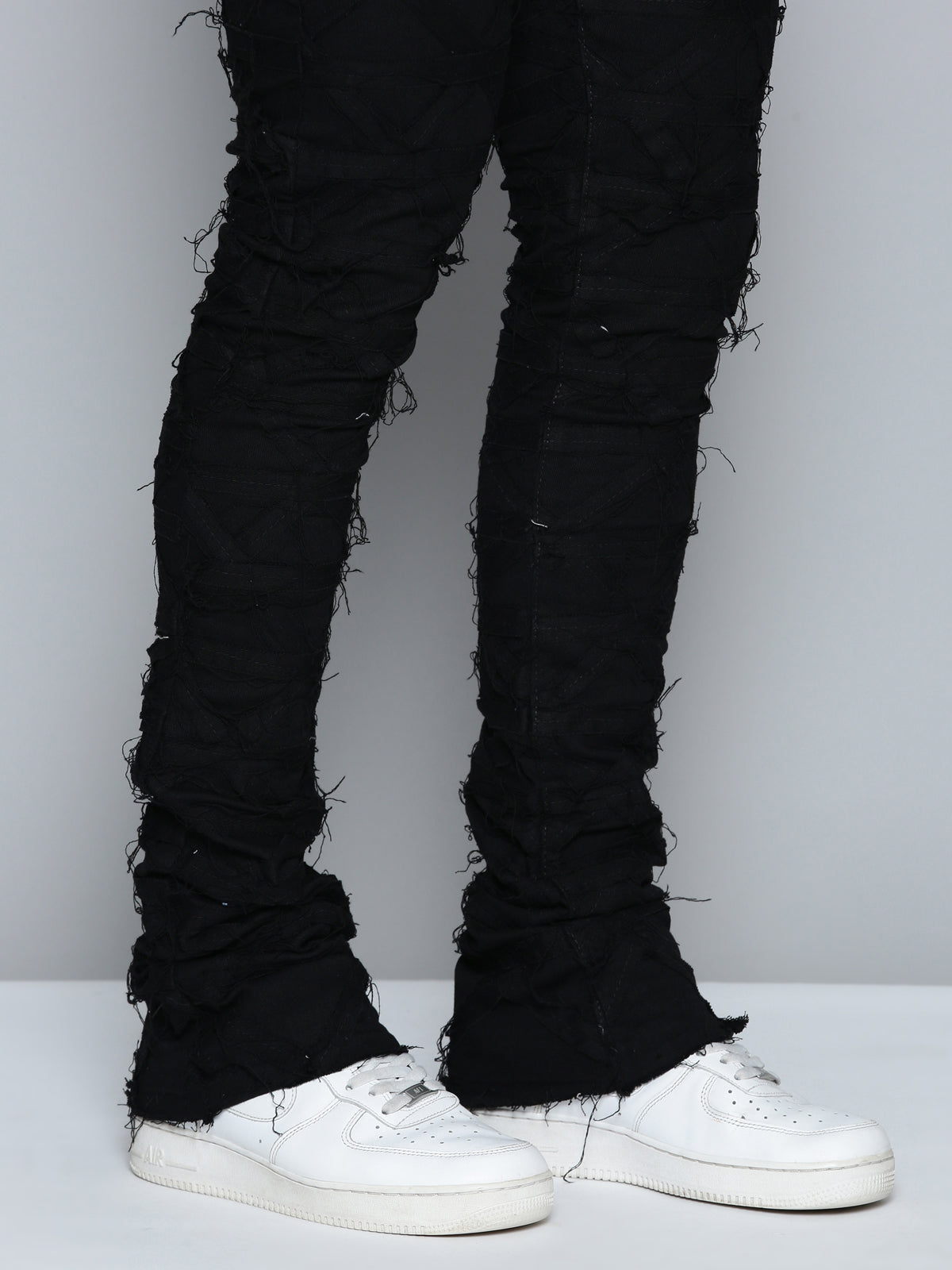 JET BLACK STACKED JEAN WITH FRINGE CUT AND SEW FROM TOP TO BOTTOM
