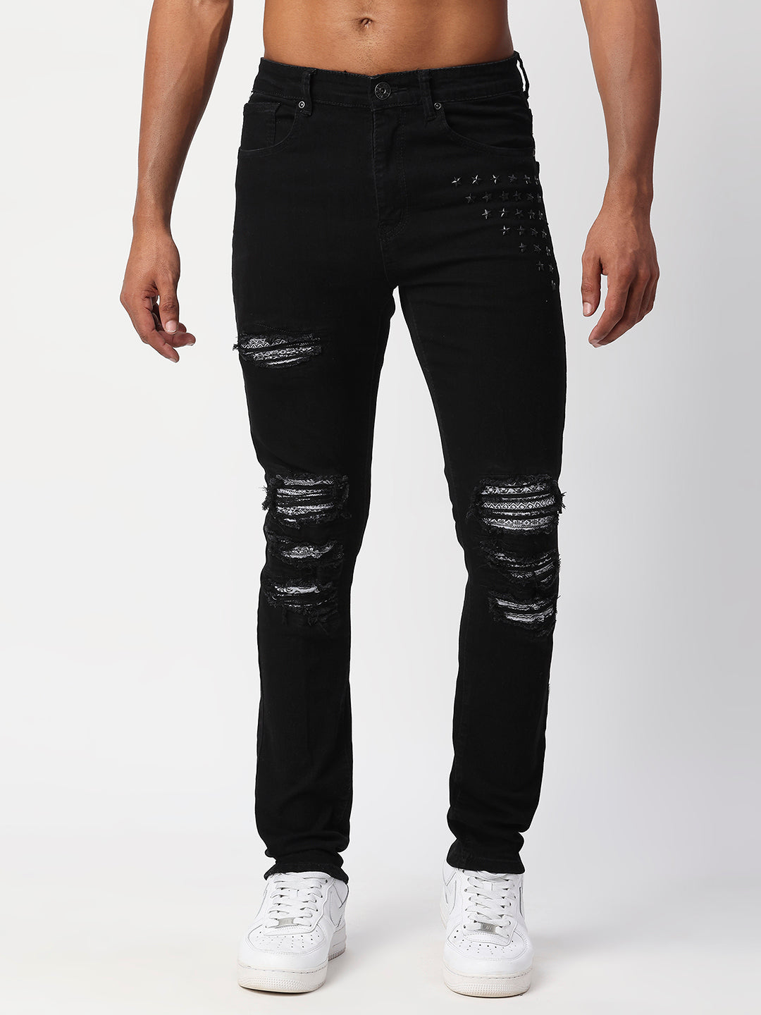JET BLACK SKINNY JEAN WITH AZTEC PRINT BACKED RIPS AND PEWTER COLOR STARS