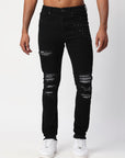 JET BLACK SKINNY JEAN WITH AZTEC PRINT BACKED RIPS AND PEWTER COLOR STARS