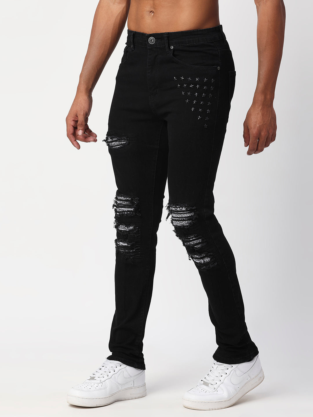 JET BLACK SKINNY JEAN WITH AZTEC PRINT BACKED RIPS AND PEWTER COLOR STARS