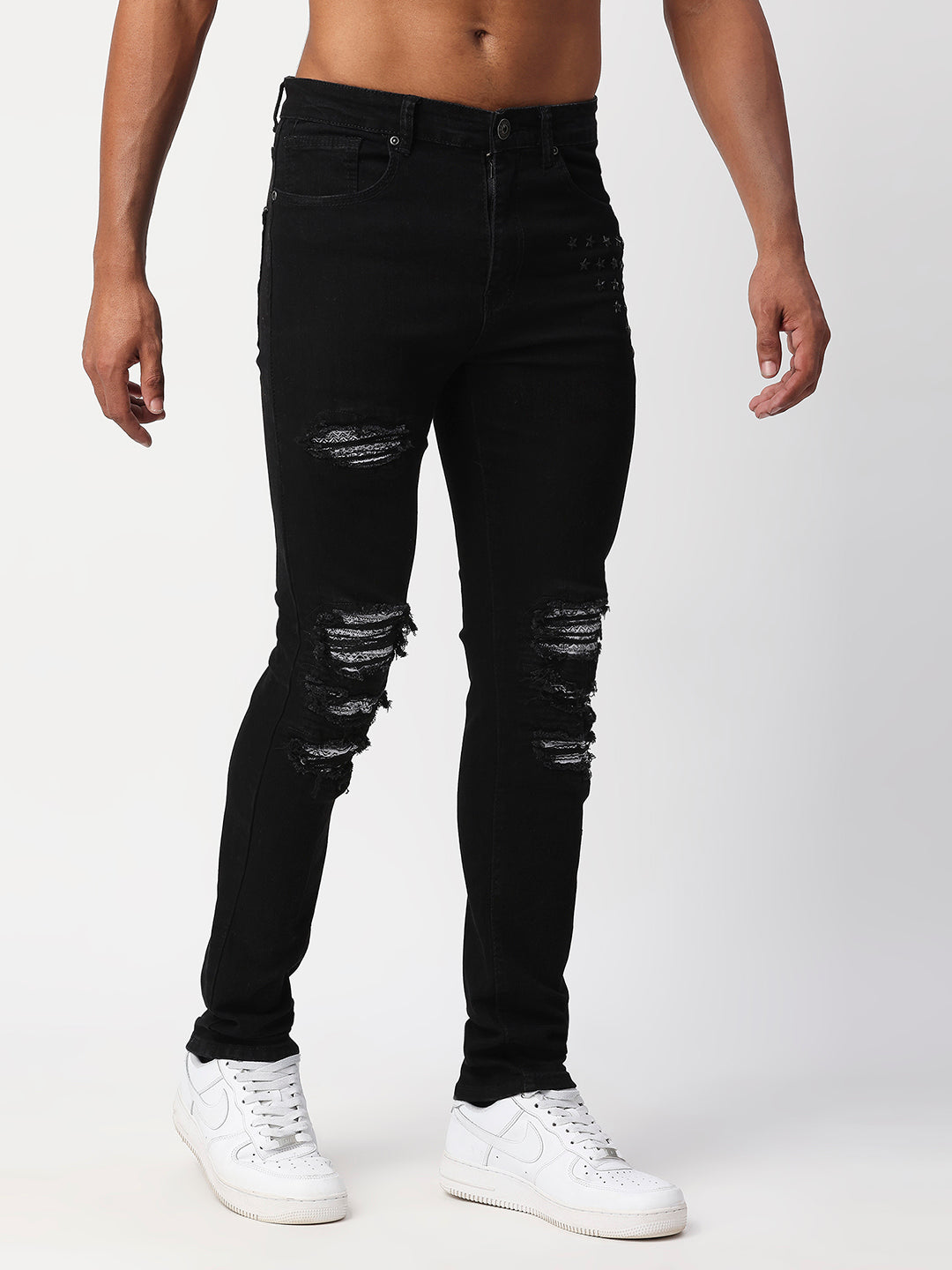 JET BLACK SKINNY JEAN WITH AZTEC PRINT BACKED RIPS AND PEWTER COLOR STARS