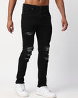 JET BLACK SKINNY JEAN WITH AZTEC PRINT BACKED RIPS AND PEWTER COLOR STARS