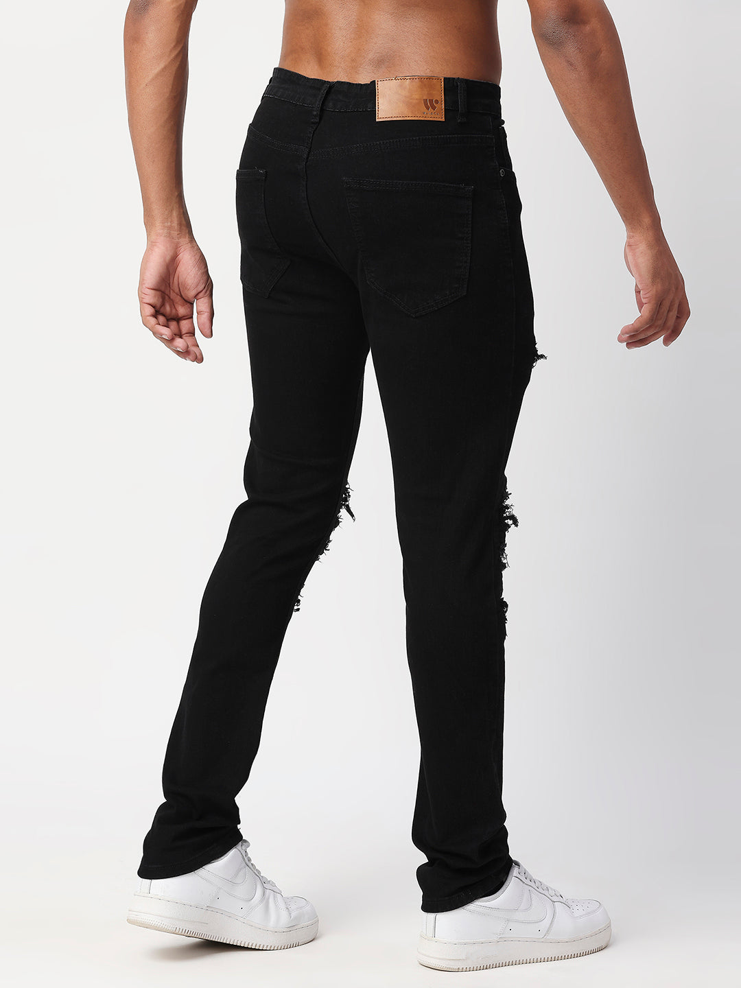 JET BLACK SKINNY JEAN WITH AZTEC PRINT BACKED RIPS AND PEWTER COLOR STARS