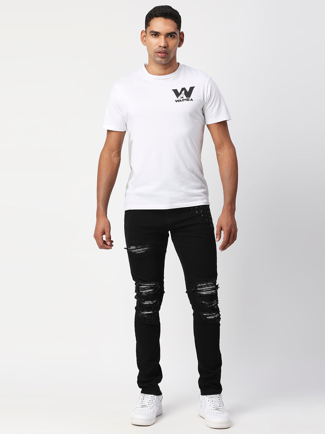 JET BLACK SKINNY JEAN WITH AZTEC PRINT BACKED RIPS AND PEWTER COLOR STARS