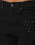 JET BLACK SKINNY JEAN WITH AZTEC PRINT BACKED RIPS AND PEWTER COLOR STARS