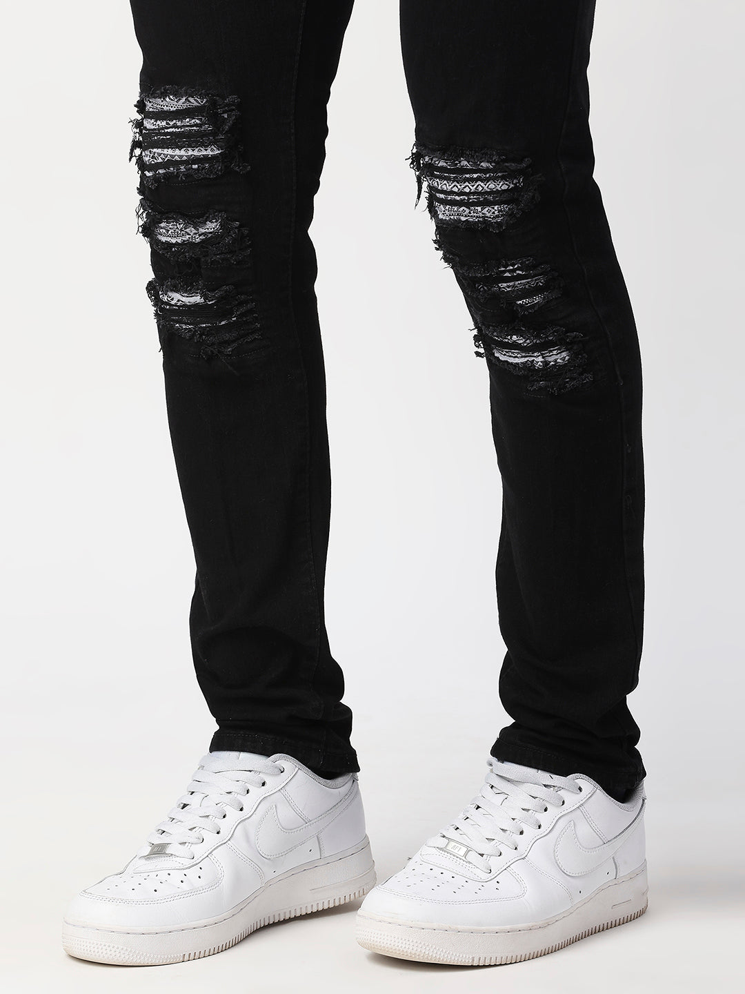JET BLACK SKINNY JEAN WITH AZTEC PRINT BACKED RIPS AND PEWTER COLOR STARS