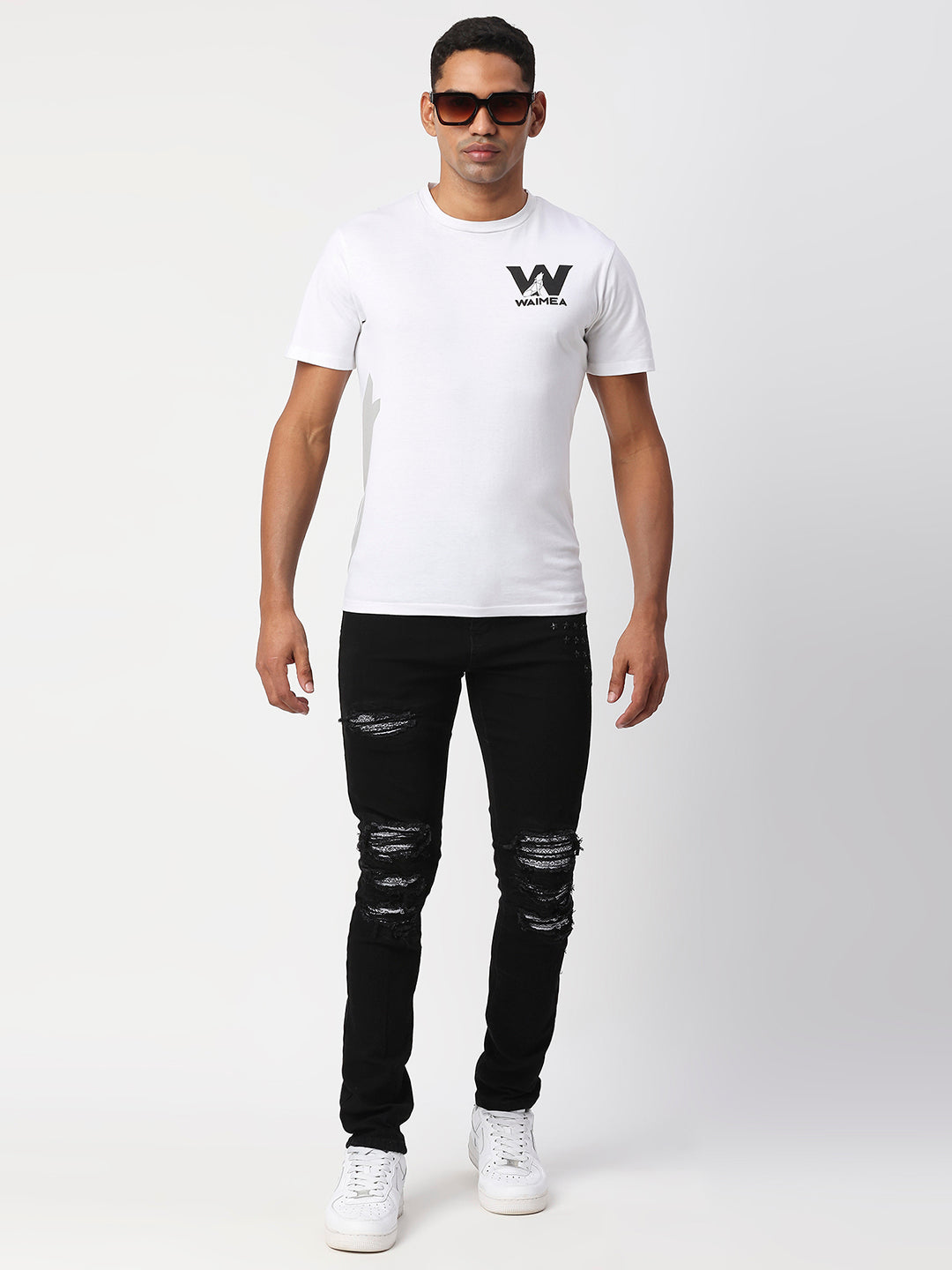 JET BLACK SKINNY JEAN WITH AZTEC PRINT BACKED RIPS AND PEWTER COLOR STARS